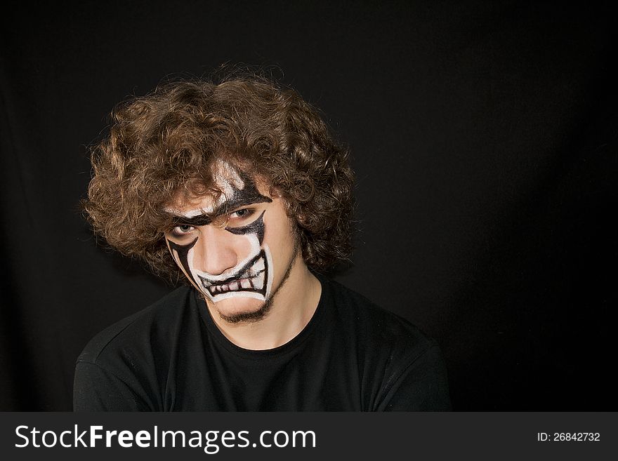 Halloween. Make-up on a face of the young man