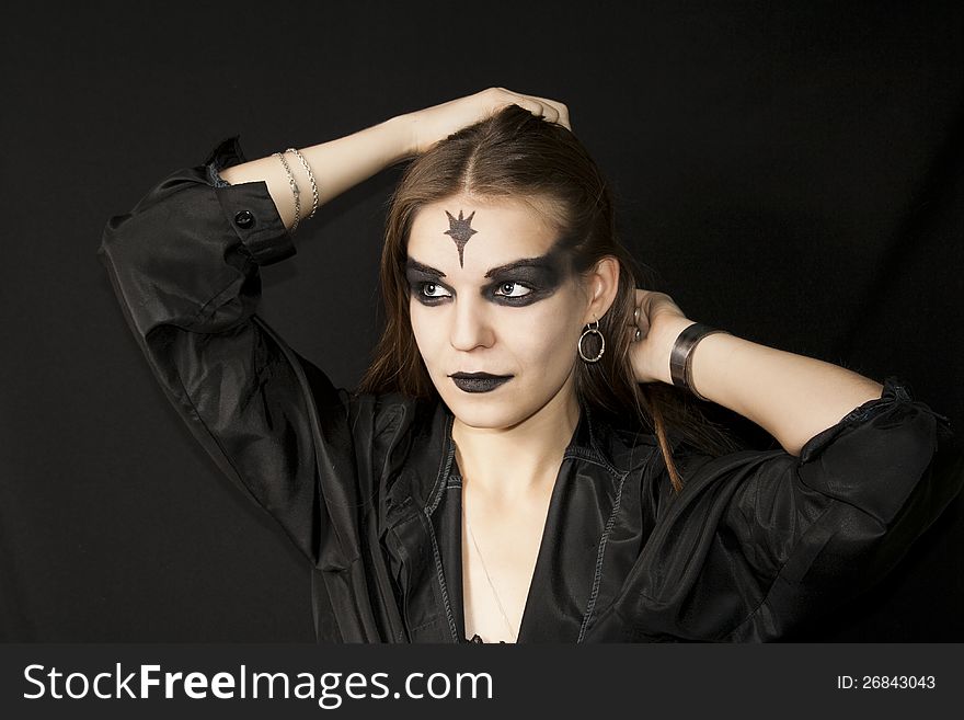 Halloween. Gothic girl with a black make-up of eyes and lips. Halloween. Gothic girl with a black make-up of eyes and lips