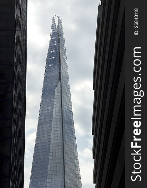 The London Shard framed either side by tall city buildings. The London Shard framed either side by tall city buildings
