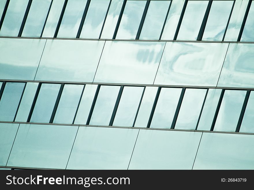 View of a modern and shiny glass skyscraper. View of a modern and shiny glass skyscraper.