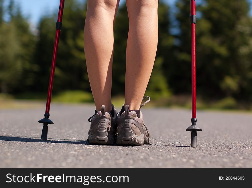 Closeup of woman's legs with nordic walking poles. Closeup of woman's legs with nordic walking poles