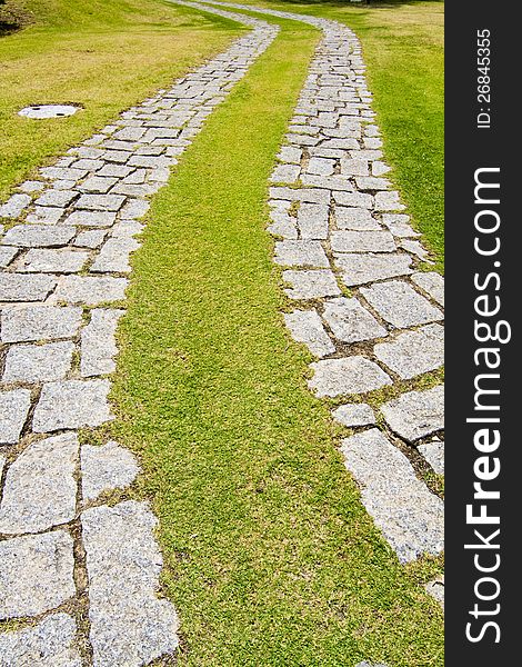 View of a curved cobblestone road on a urban park.