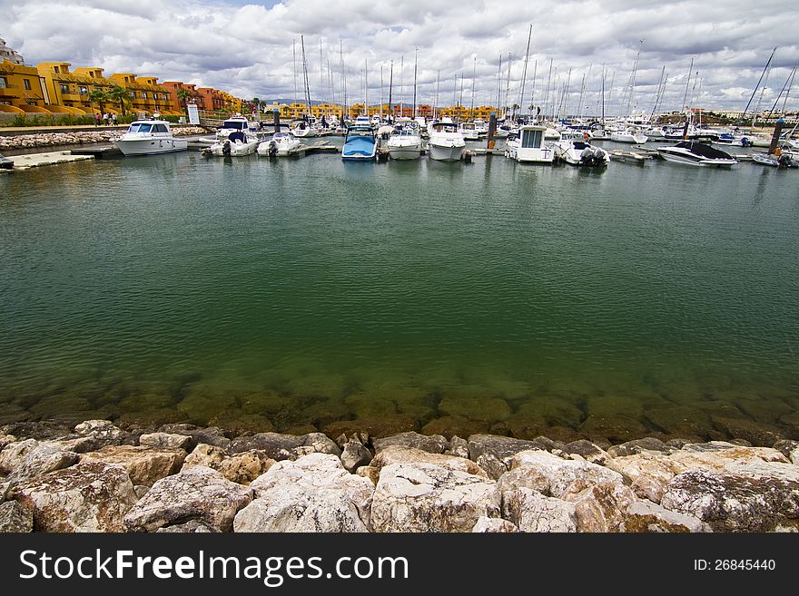 View of the beautiful marina filled with recreation boats, in Portimao, Portugal. View of the beautiful marina filled with recreation boats, in Portimao, Portugal.