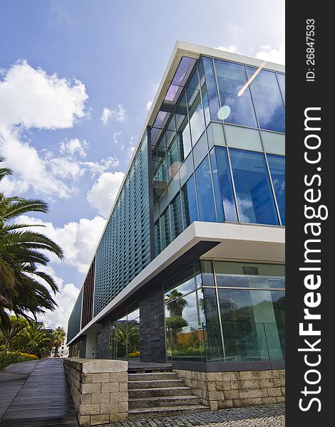 View of a modern glass building in the Parque das Nacoes area in Lisbon, Portugal. View of a modern glass building in the Parque das Nacoes area in Lisbon, Portugal.