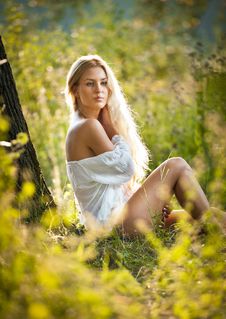 Young Woman On Field In White Dress Stock Images