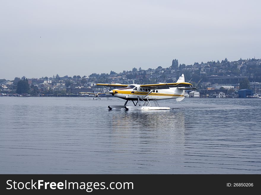 A float-plane was landing on a lake. A float-plane was landing on a lake