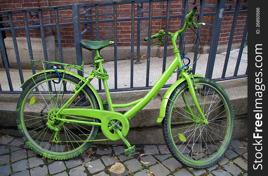 Vintage beauty green bicycle on a street. Vintage beauty green bicycle on a street