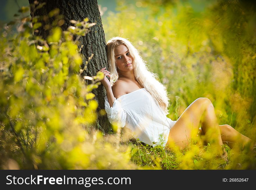 Young Woman On Field In White Dress