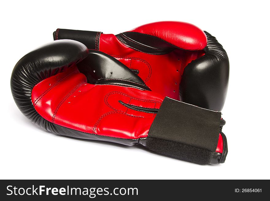 Close view of some red boxing gloves isolated on a white background.