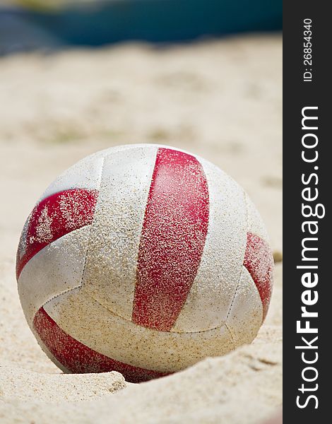 Close view detail of a beach ball covered in sand on a beach. Close view detail of a beach ball covered in sand on a beach.