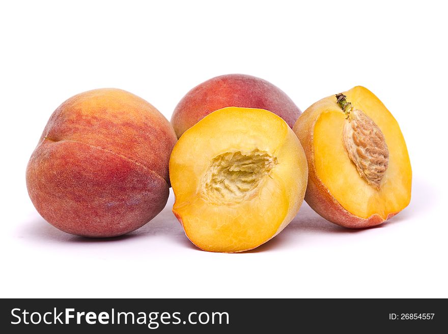 Close view of some tasty peaches isolated on a white background. Close view of some tasty peaches isolated on a white background.