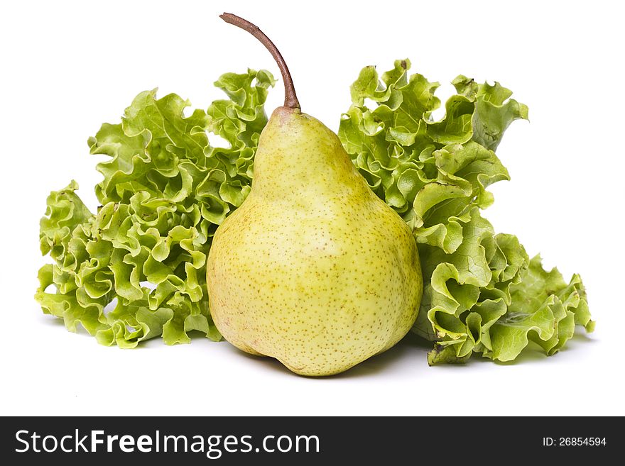 Close view of a tasty green pear with lettuce isolated on a white background. Close view of a tasty green pear with lettuce isolated on a white background.
