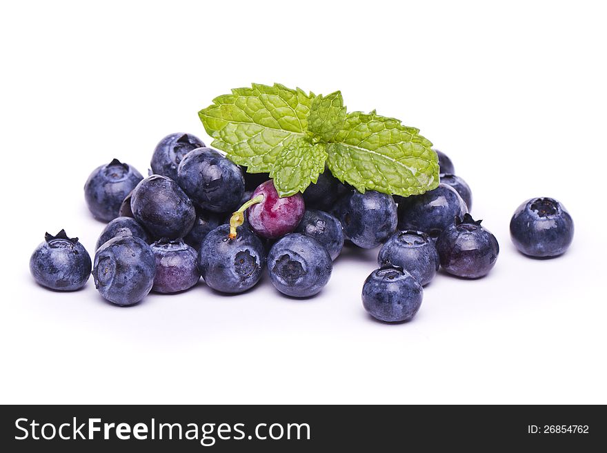 View of a bunch of tasty blueberries (Vaccinium myrtillus) isolated on a white background.