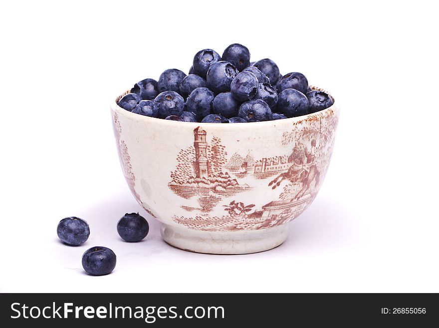 View of a bunch of tasty blueberries (Vaccinium myrtillus) isolated on a white background.