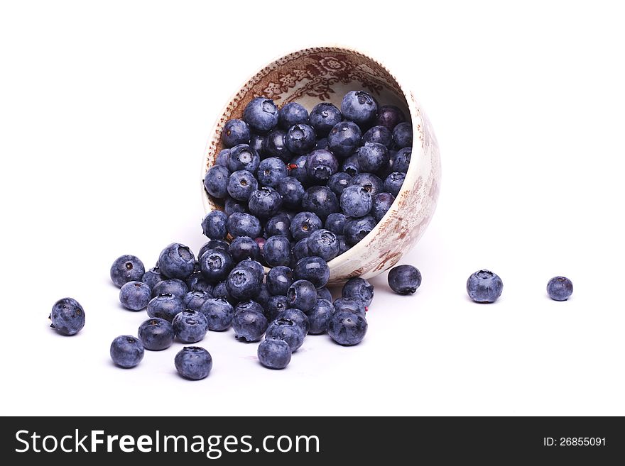 View of a bunch of tasty blueberries (Vaccinium myrtillus) isolated on a white background.