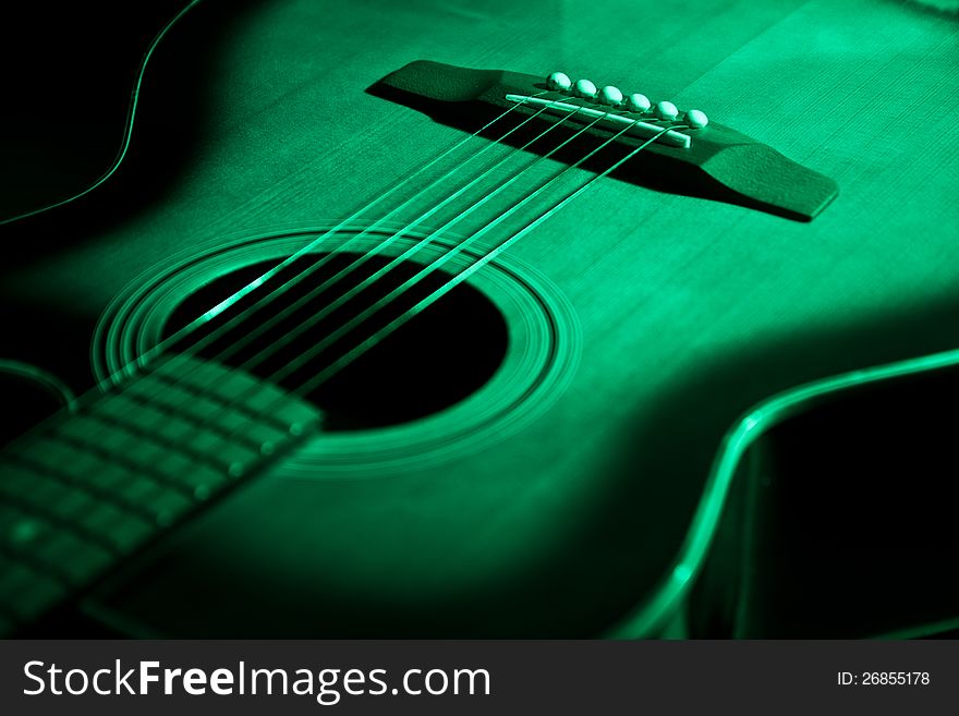 Green acoustic guitar in soft light. Green acoustic guitar in soft light