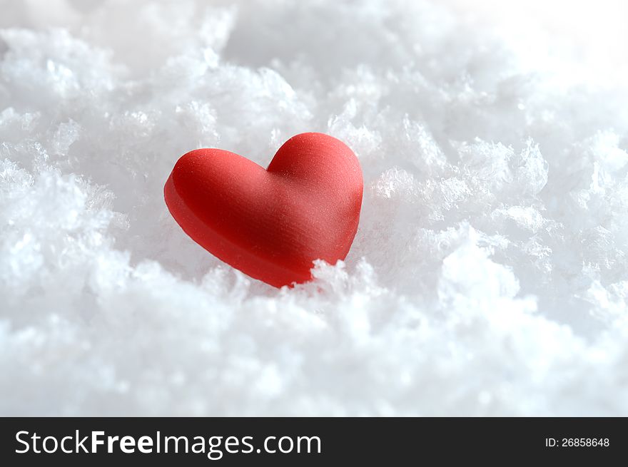 Macro image of a red heart lying on fresh snow. Copy space. Macro image of a red heart lying on fresh snow. Copy space.