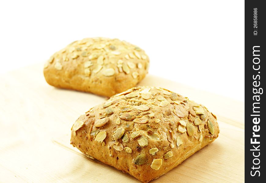 Bread with seeds on a wooden board