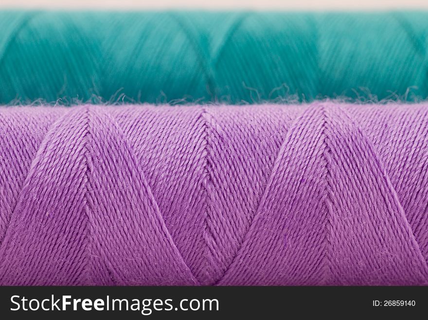 Closeup of violet and green thread