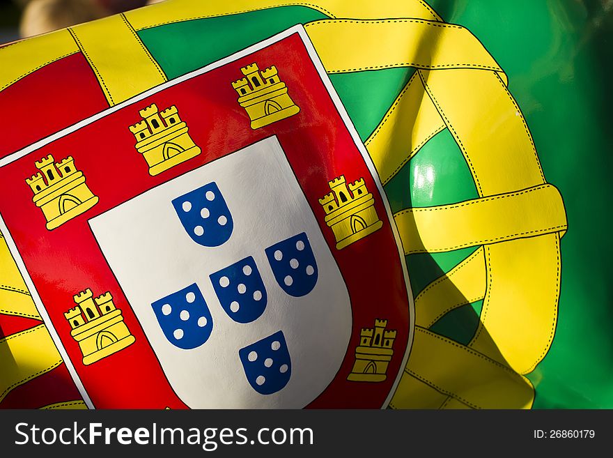 Close up view of a Portuguese flag pattern on a surface.