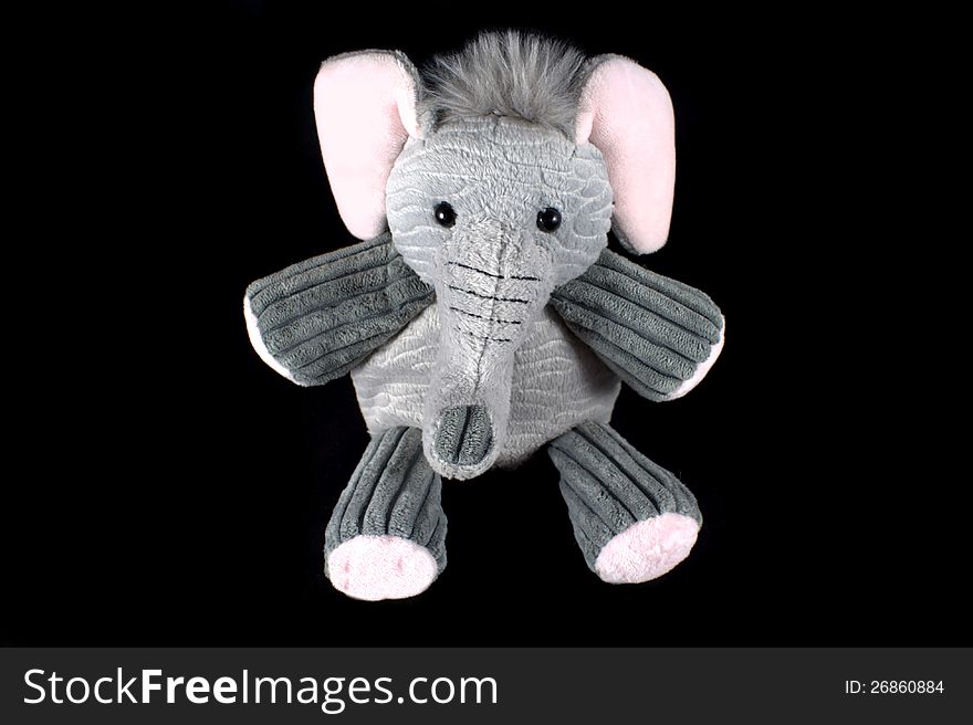 Baby's stuffed elephant on black background. Baby's stuffed elephant on black background