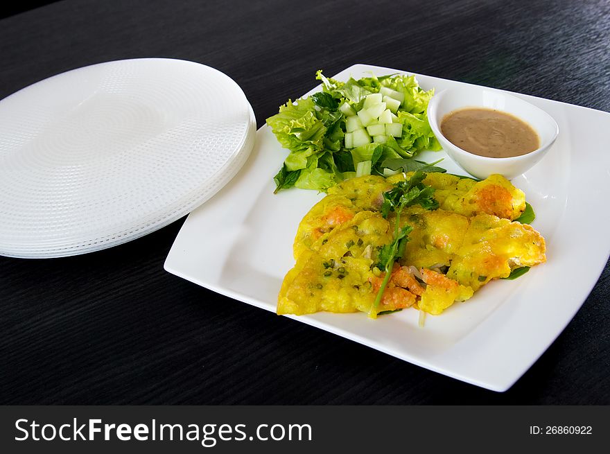 Vietnamese food round rice disc with shrimp in omelette flat rice dish set on the table. Vietnamese food round rice disc with shrimp in omelette flat rice dish set on the table