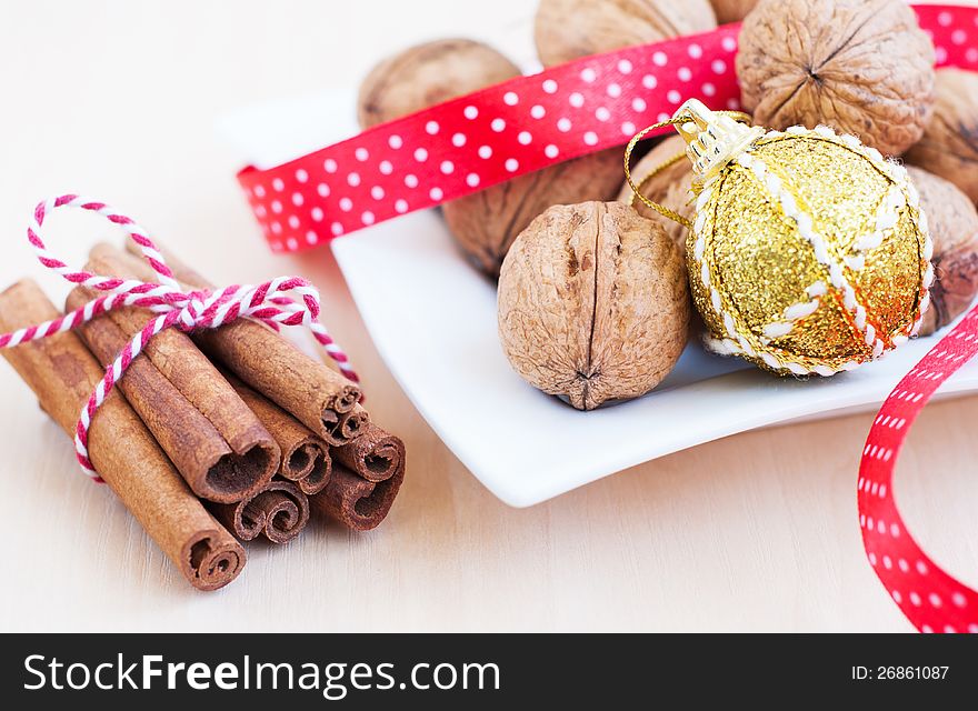 Christmas still life with walnuts, ribbon and cinnamon sticks. Christmas still life with walnuts, ribbon and cinnamon sticks