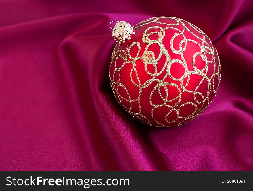 Christmas bauble on the red silk  background