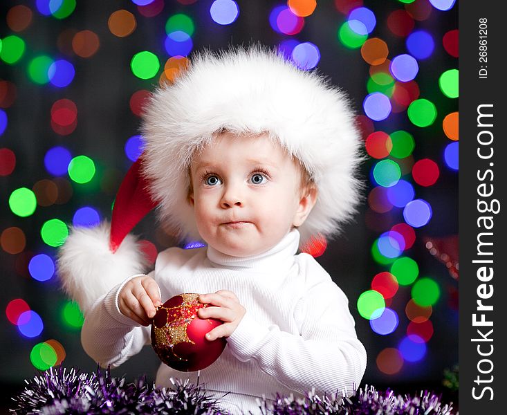 Baby boy in Santa Claus hat on bright festive background. Baby boy in Santa Claus hat on bright festive background