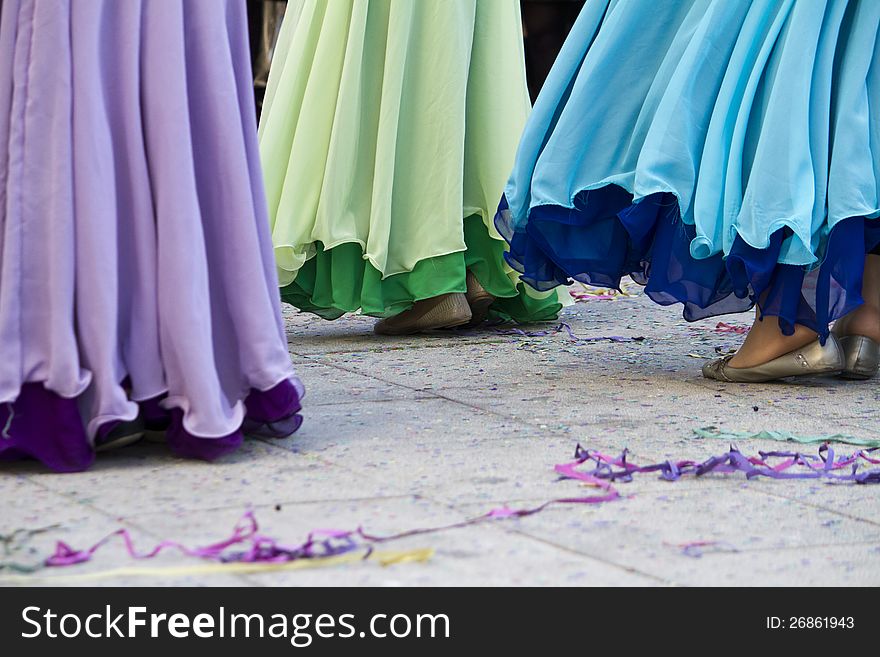 View of some girls with colorful dresses dancing on the Carnival festivity. View of some girls with colorful dresses dancing on the Carnival festivity.