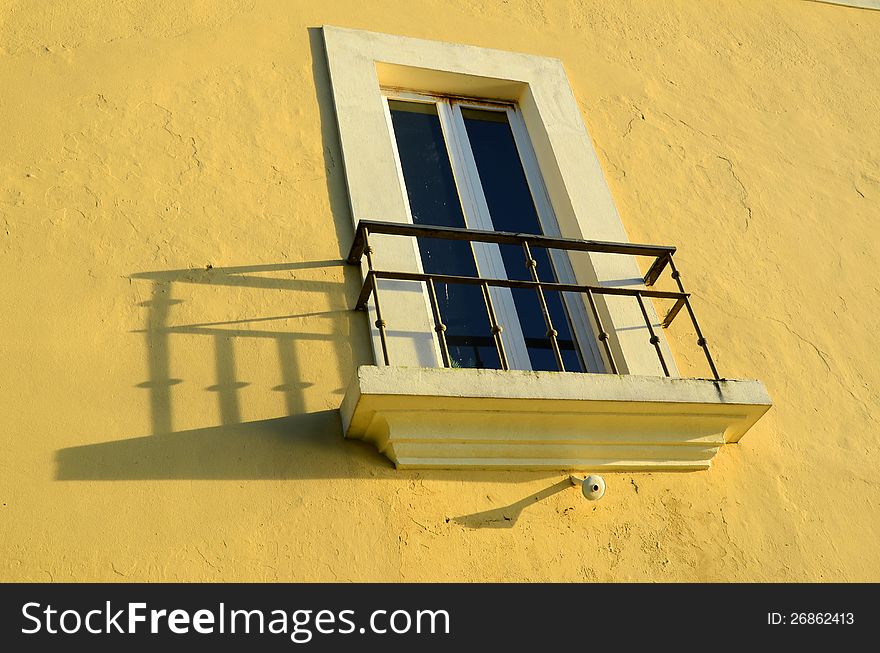 White window on yellow wall