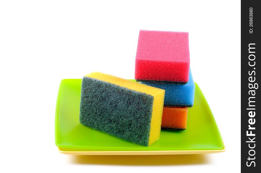 Colorful Dish sponge on a plastic plates, white background. Colorful Dish sponge on a plastic plates, white background