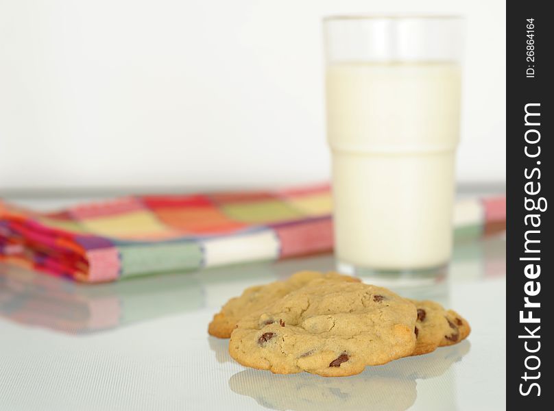 Fresh homemade chocolate chip cookies and a glass of milk. Fresh homemade chocolate chip cookies and a glass of milk.