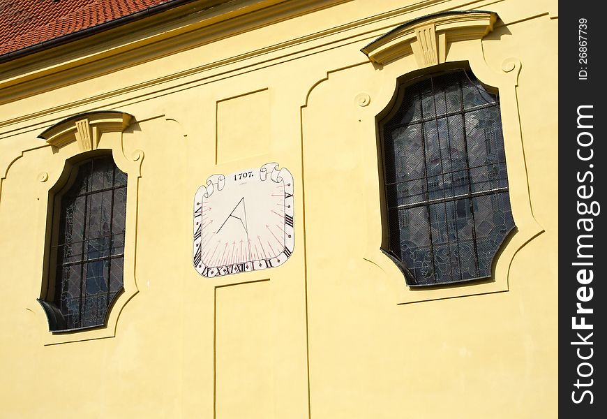 The sundial on the yellow wall of the old church. The sundial on the yellow wall of the old church.