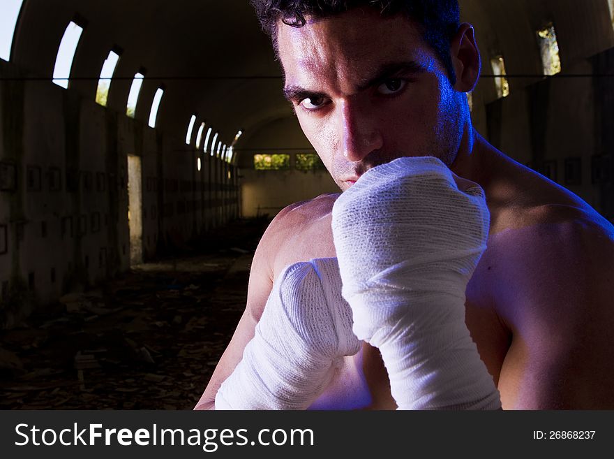 View of a fit fighter on a abandoned factory.