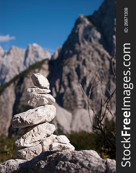 Stack stone with not in focus background high Alp mountains. Stack stone with not in focus background high Alp mountains