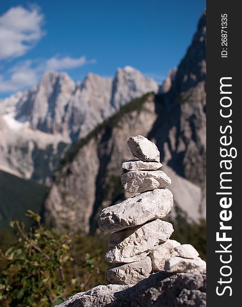 Stack stone with not in focus background high Alp mountains. Stack stone with not in focus background high Alp mountains