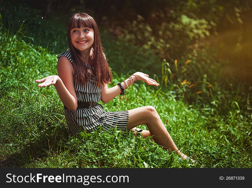 Girl Sitting On A Grass