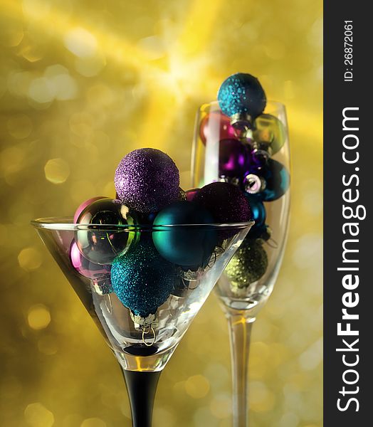 Christmas baubles in wineglasses on a dark background. Christmas baubles in wineglasses on a dark background.