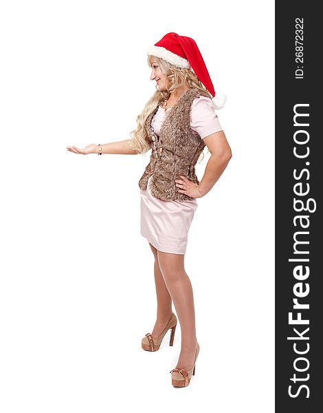 Beautiful blonde girl wearing a Santa's hat standing with her hand up, place your product here. Beautiful blonde girl wearing a Santa's hat standing with her hand up, place your product here