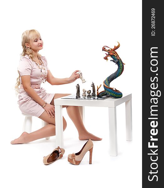 girl playing chess with a decorative dragon