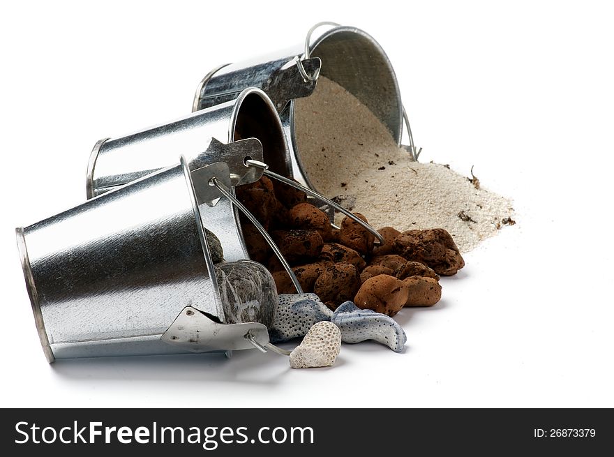 Tin Buckets with Spilled Gravel, Sand and Stones in a Row isolated on white background