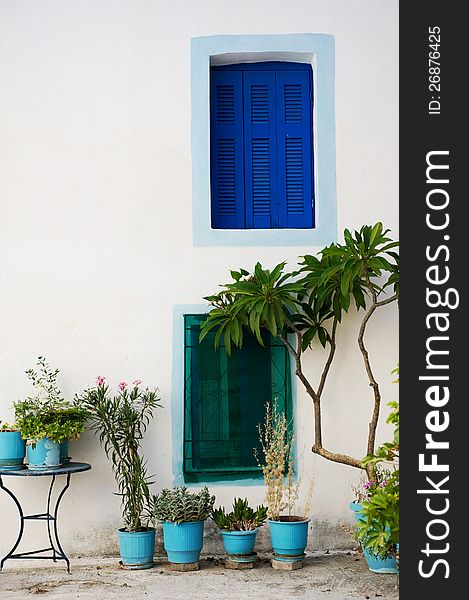 Wall with colored windows from a traditional Greek house in Poros island. Wall with colored windows from a traditional Greek house in Poros island