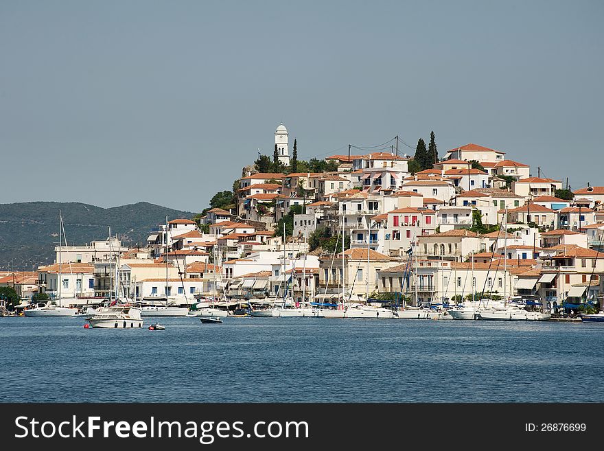 View of the village and a tower on the hill, Poros island, Greece. View of the village and a tower on the hill, Poros island, Greece
