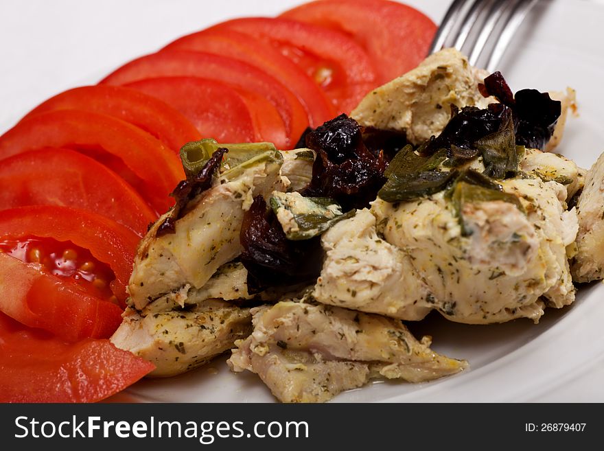 Close-up chicken breast with prunes and tomatoes