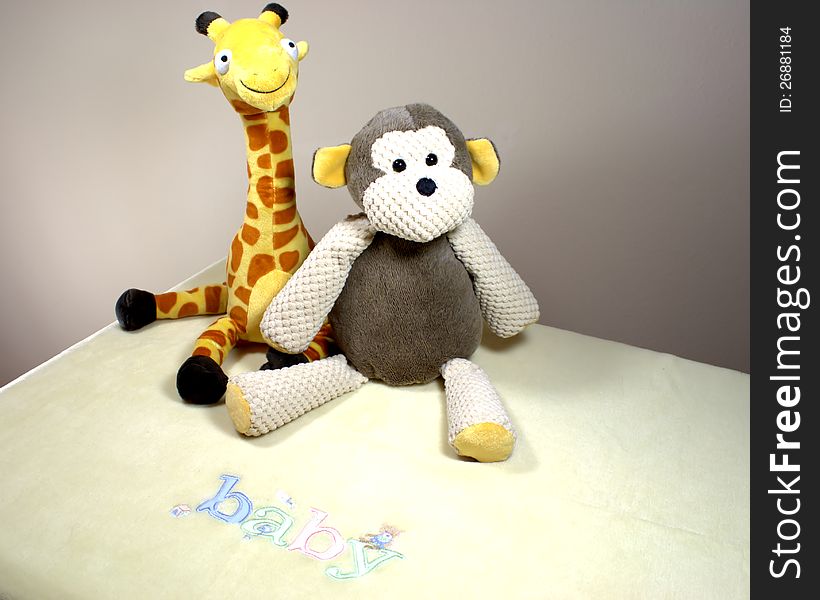 Monkey and giraffe on a yellow baby blanket. Monkey and giraffe on a yellow baby blanket