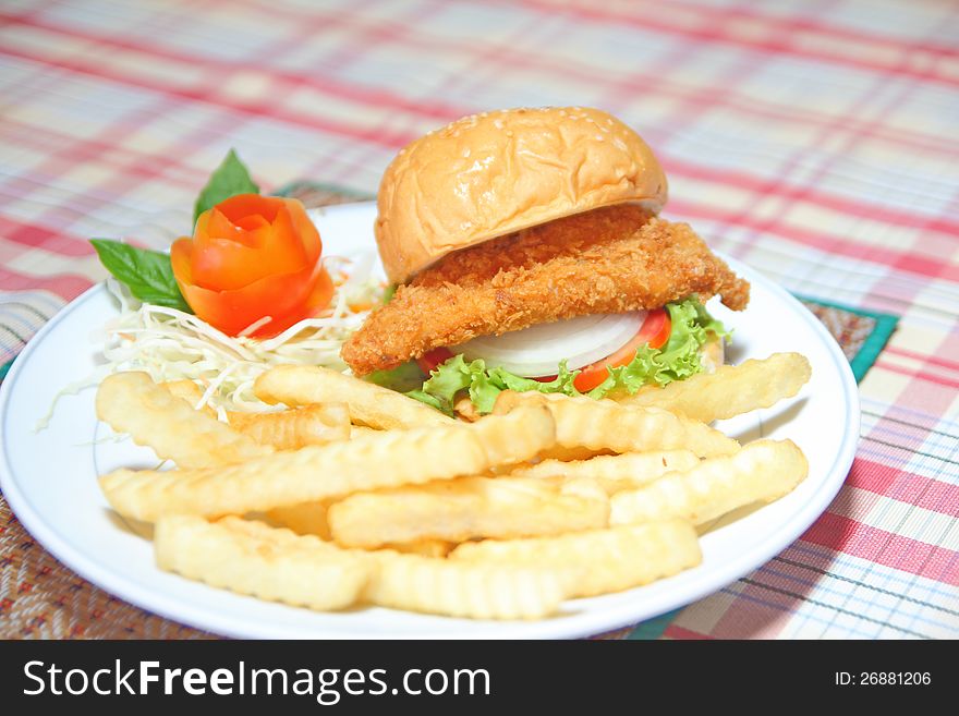 Deep fried chicken burger with fench fire on white plate. Deep fried chicken burger with fench fire on white plate