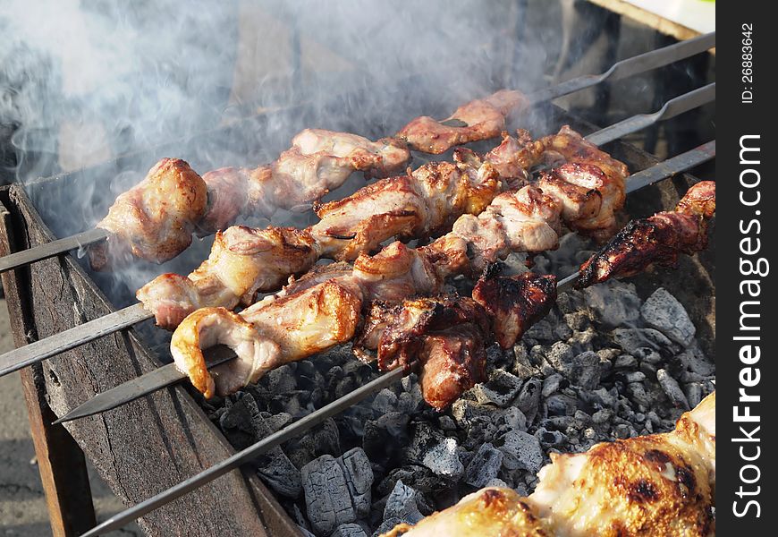 Photo cooking shish kebab on the coals. Photo cooking shish kebab on the coals