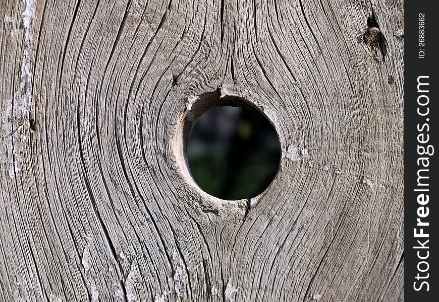 Hoto holes in the wooden fence close-UPS. Hoto holes in the wooden fence close-UPS.