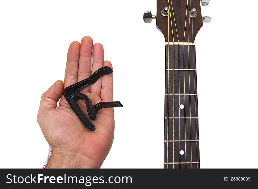 Hand holding a guitar capo